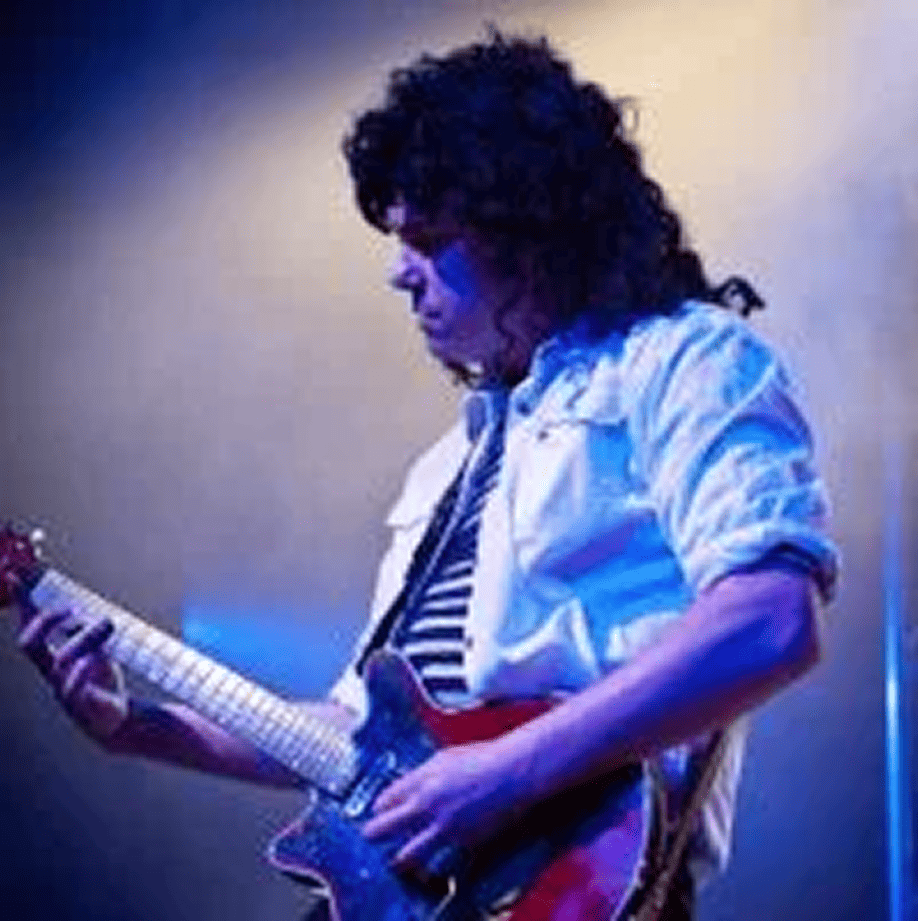 Scott Bastian portraying Brian May in Queen Forever, showcasing authentic guitar work and signature tone in Australia’s leading Queen tribute production
